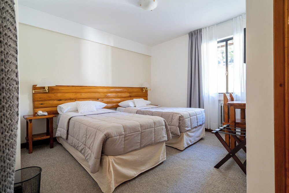 Quarto do Gran Hotel Panamericano com camas e aquecimento
